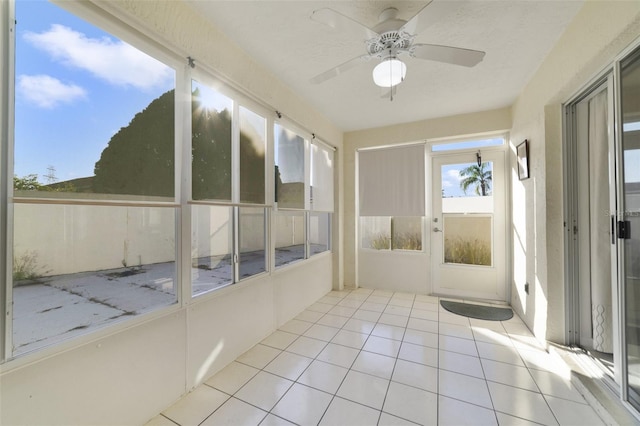 unfurnished sunroom featuring ceiling fan