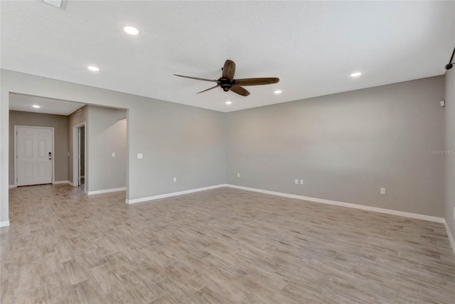 spare room with light hardwood / wood-style floors and ceiling fan