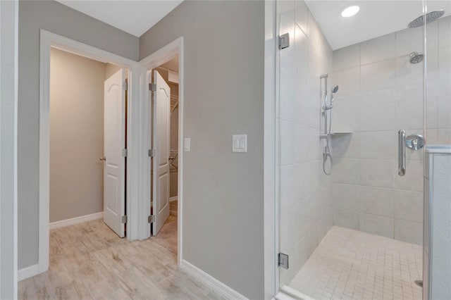 bathroom featuring an enclosed shower and wood-type flooring