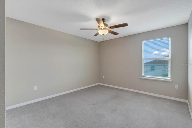 unfurnished room featuring ceiling fan and light colored carpet