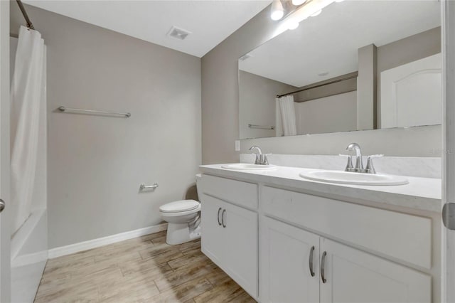 full bathroom featuring vanity, toilet, and shower / bath combo with shower curtain