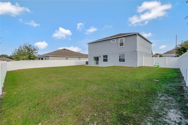 rear view of property with a lawn