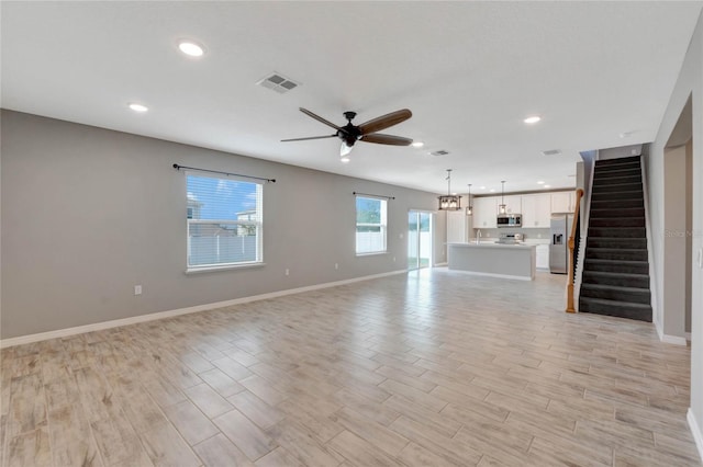 unfurnished living room featuring ceiling fan