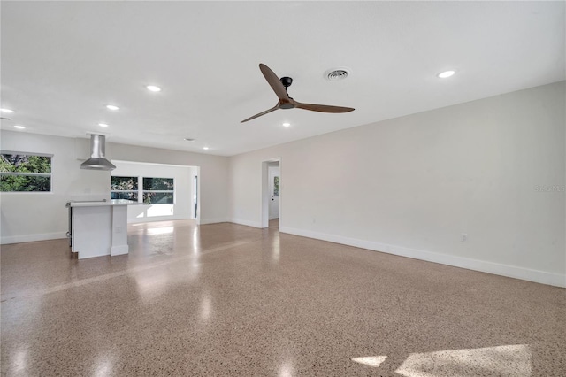 unfurnished living room with ceiling fan