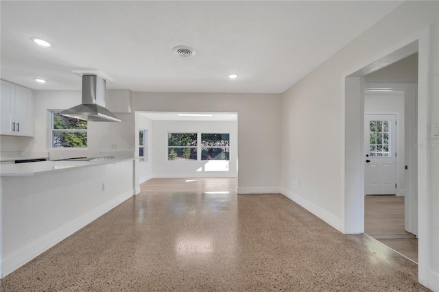 unfurnished living room featuring a healthy amount of sunlight