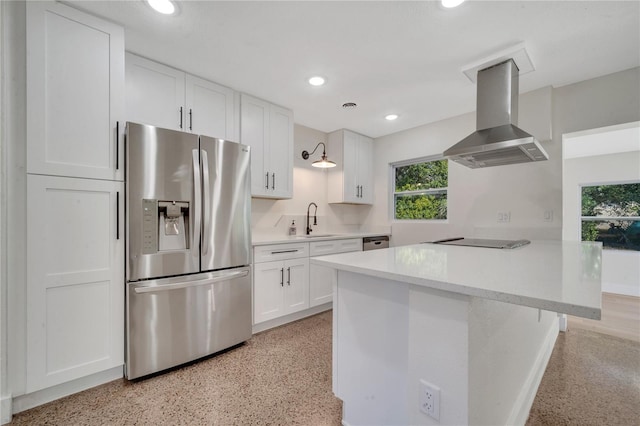 kitchen featuring sink, white cabinetry, stainless steel appliances, and range hood