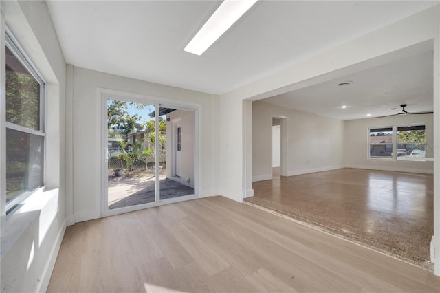 unfurnished living room featuring light hardwood / wood-style flooring and ceiling fan