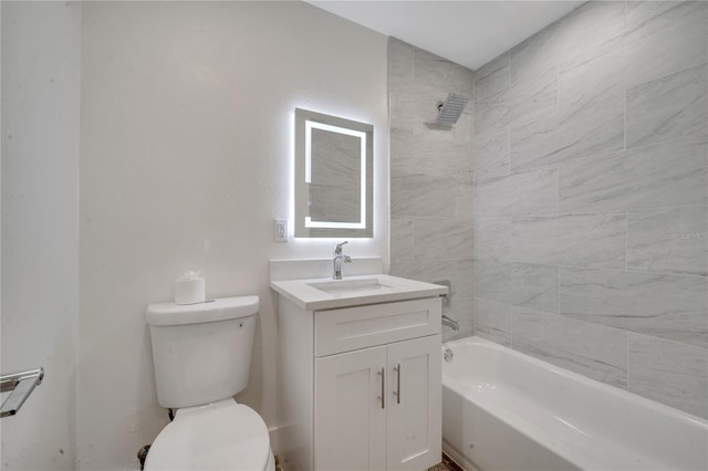 full bathroom with tiled shower / bath, vanity, and toilet