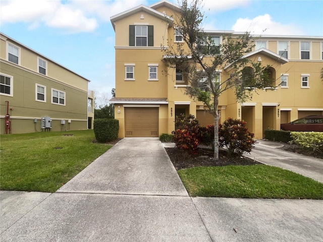 multi unit property with a front yard and a garage