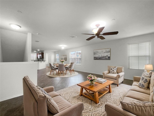 tiled living room with ceiling fan