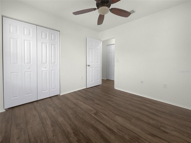 unfurnished bedroom featuring ceiling fan, a closet, and dark hardwood / wood-style floors