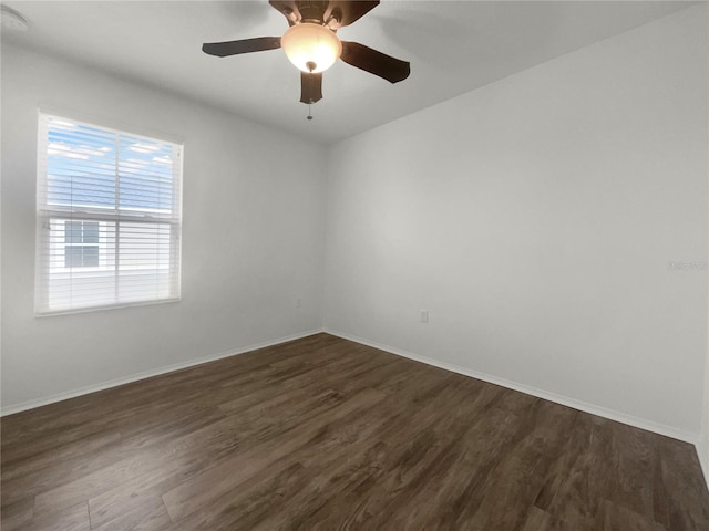 empty room with dark hardwood / wood-style floors and ceiling fan