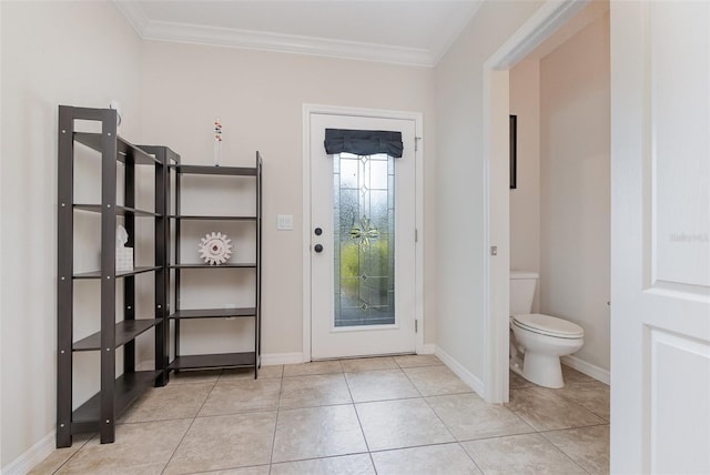 doorway to outside with crown molding and light tile patterned floors