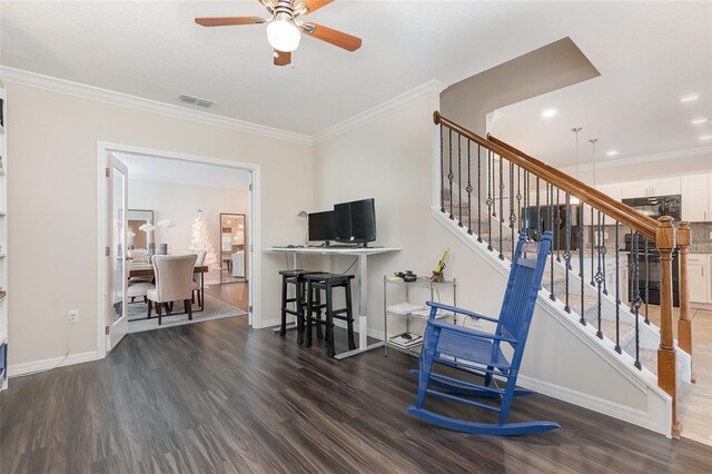 interior space with crown molding, ceiling fan, and dark wood-type flooring