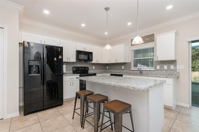 kitchen with white cabinets, plenty of natural light, and black appliances