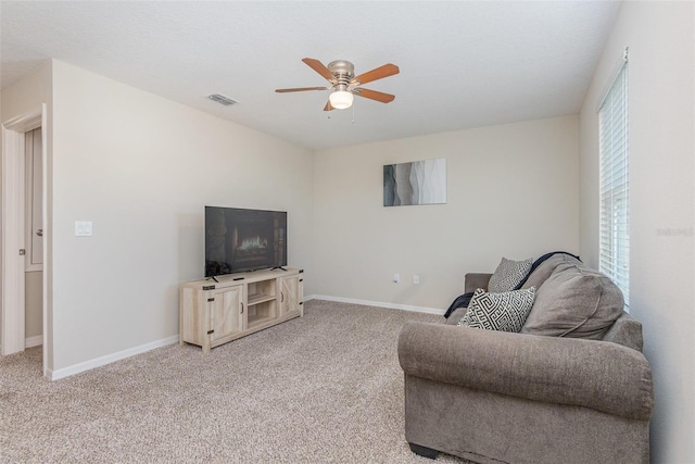 carpeted living room featuring ceiling fan