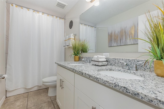 bathroom with tile patterned flooring, vanity, curtained shower, and toilet