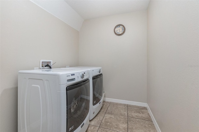 washroom with light tile patterned floors and washer and dryer