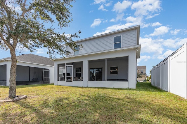 back of house featuring a sunroom and a yard