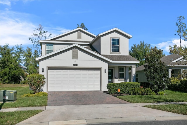 front facade with a garage and a front lawn