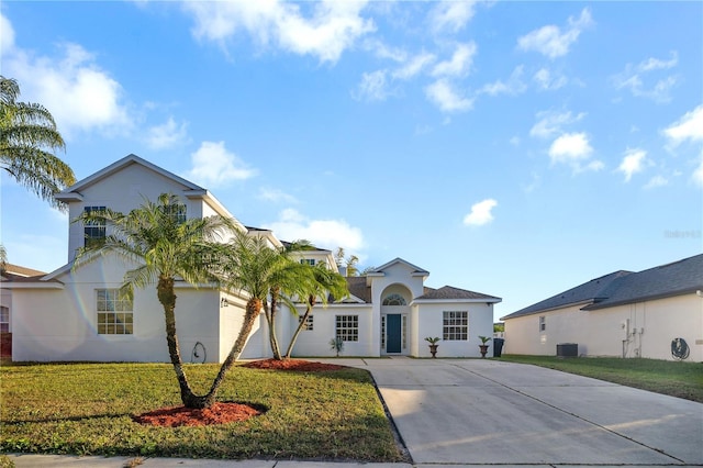 view of front of property with a front yard and central AC unit