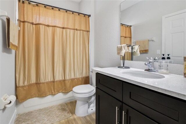 full bathroom with shower / bath combo, toilet, wood-type flooring, and vanity