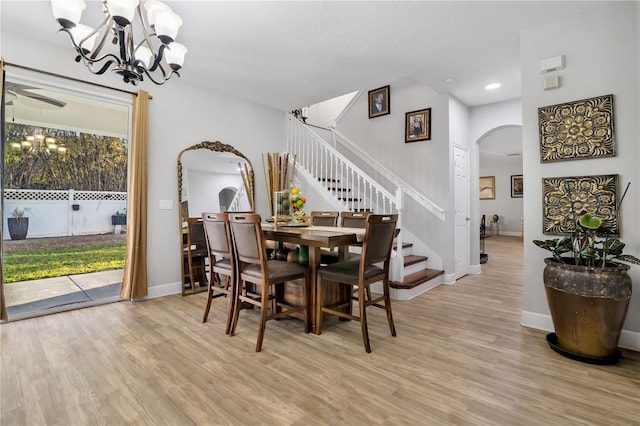 dining area with a chandelier and light hardwood / wood-style flooring