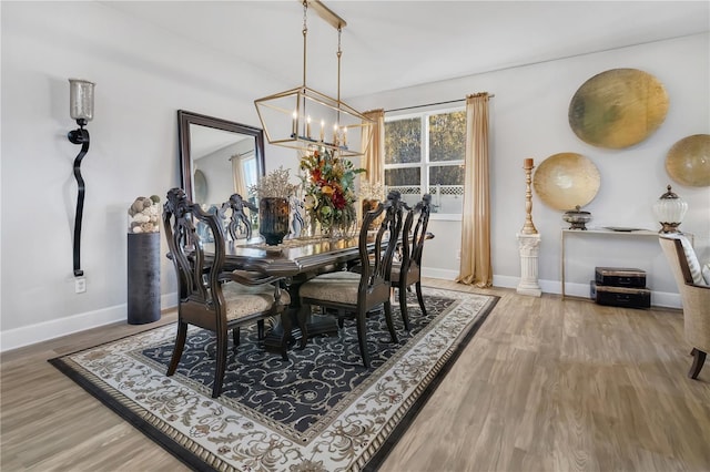 dining room featuring a chandelier and wood-type flooring