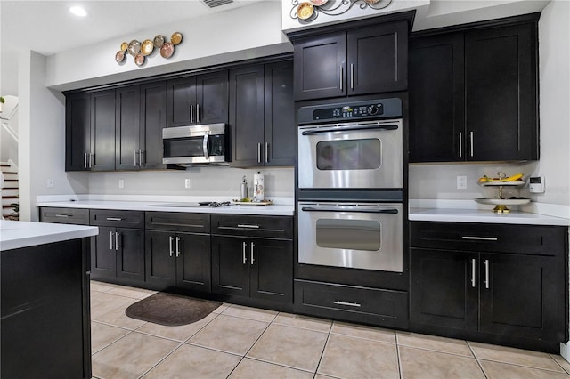 kitchen with light tile patterned flooring and stainless steel appliances