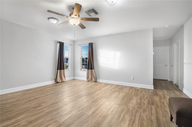 empty room featuring hardwood / wood-style floors and ceiling fan