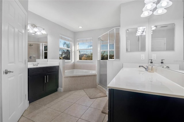 bathroom featuring tile patterned floors, vanity, and shower with separate bathtub