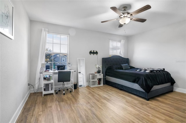 bedroom with ceiling fan and wood-type flooring