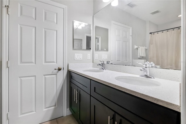 bathroom featuring tile patterned flooring and vanity