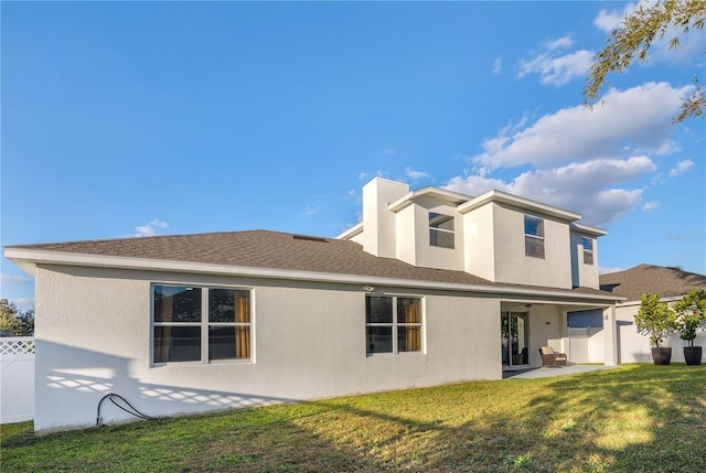 back of property with a lawn and a patio