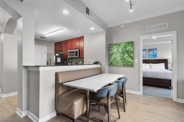 14501 Grove Resort Ave Unit 1727, Winter Garden, FL 34787 - kitchen with stainless steel appliances, dark brown cabinets, light wood-style flooring, baseboards, and recessed lighting