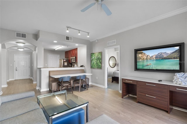 14501 Grove Resort Ave Unit 1727, Winter Garden, FL 34787 - living room featuring arched walkways, light wood finished floors, ceiling fan, baseboards, and ornamental molding