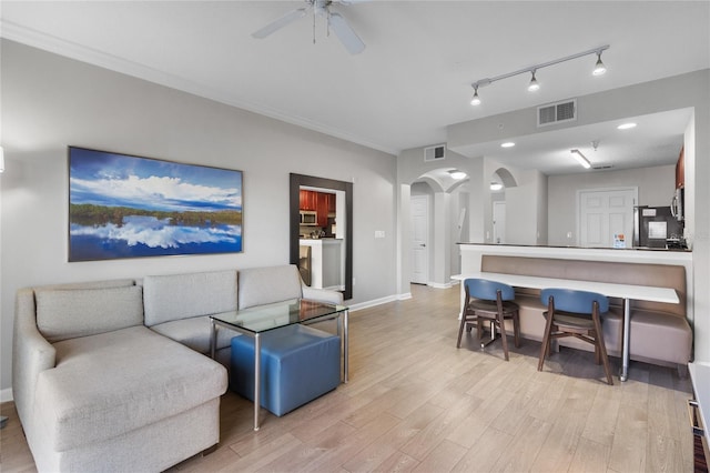 14501 Grove Resort Ave Unit 1727, Winter Garden, FL 34787 - living area featuring arched walkways, light wood-style floors, ceiling fan, baseboards, and track lighting