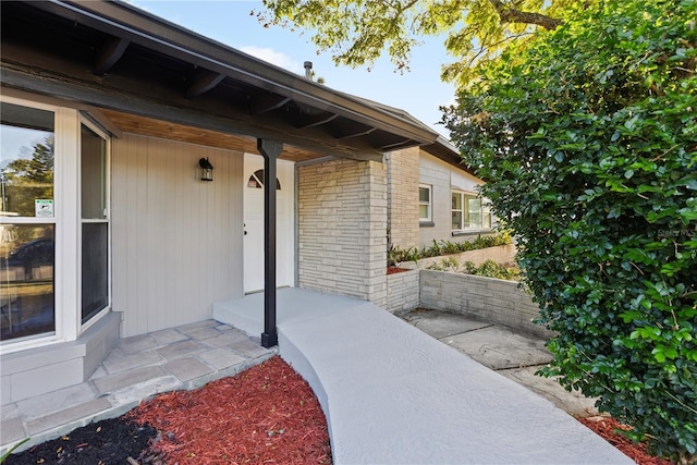 view of exterior entry featuring a porch