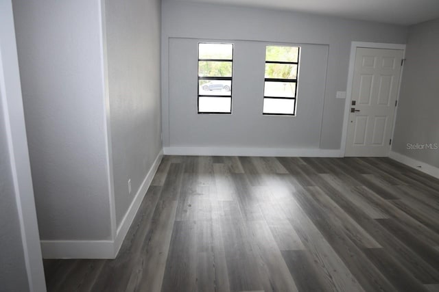 empty room with dark hardwood / wood-style floors