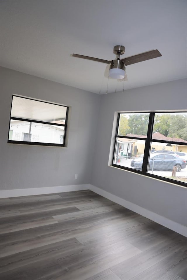 spare room with hardwood / wood-style flooring and ceiling fan