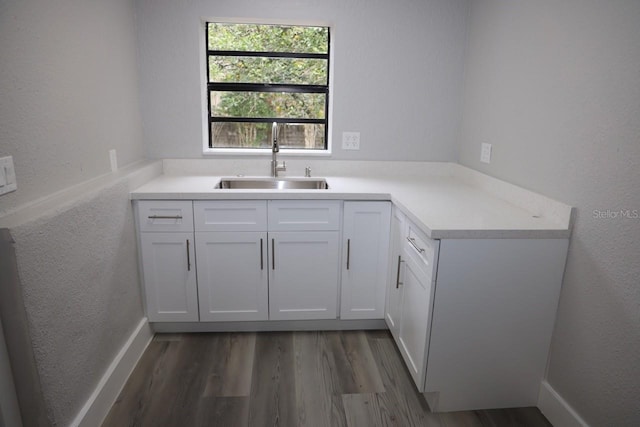 kitchen featuring sink, white cabinets, and dark hardwood / wood-style floors