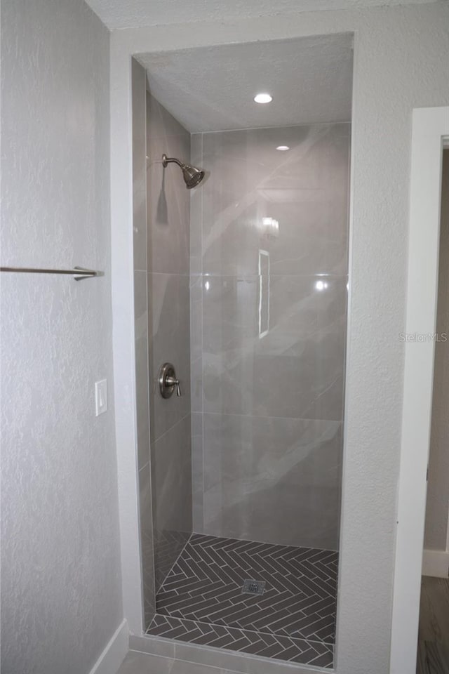 bathroom featuring a tile shower and tile patterned floors