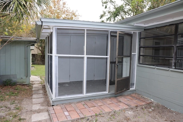 view of outdoor structure featuring a sunroom