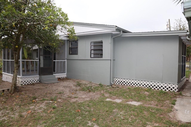 view of side of property featuring a sunroom