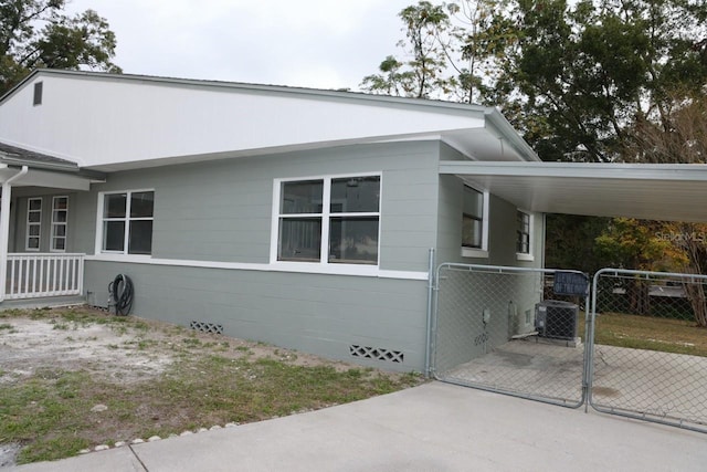 view of home's exterior featuring central AC and a carport