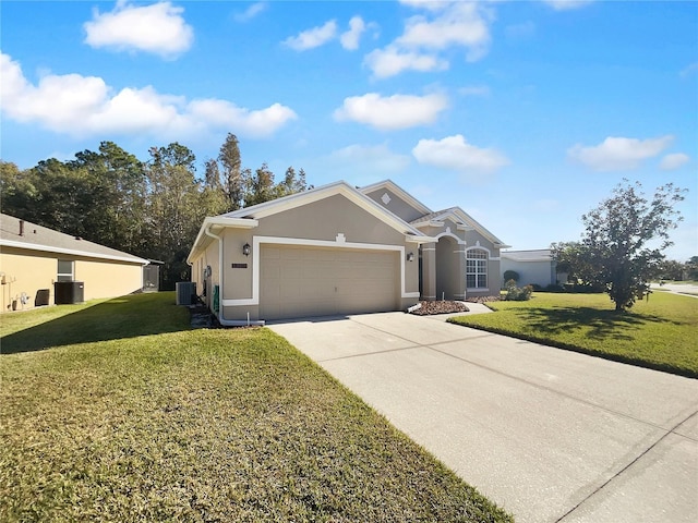 ranch-style home with cooling unit, a front yard, and a garage