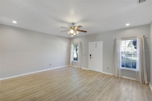 unfurnished room with ceiling fan and light wood-type flooring