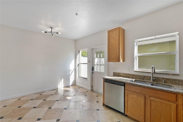 kitchen with dishwasher, a textured ceiling, and sink