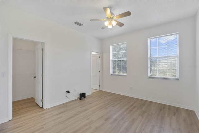 unfurnished room with ceiling fan and light wood-type flooring