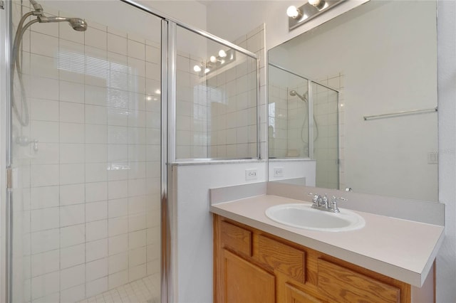 bathroom with a shower with door and vanity